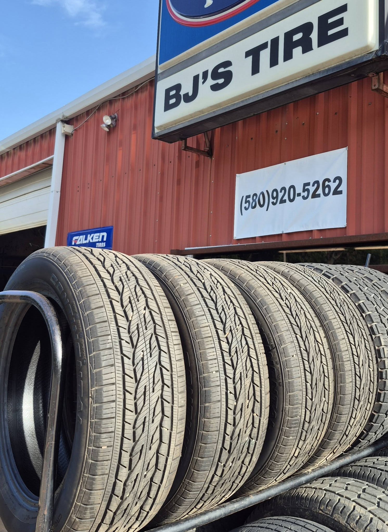 A rack of quality used tires under the BJ's Tire sign